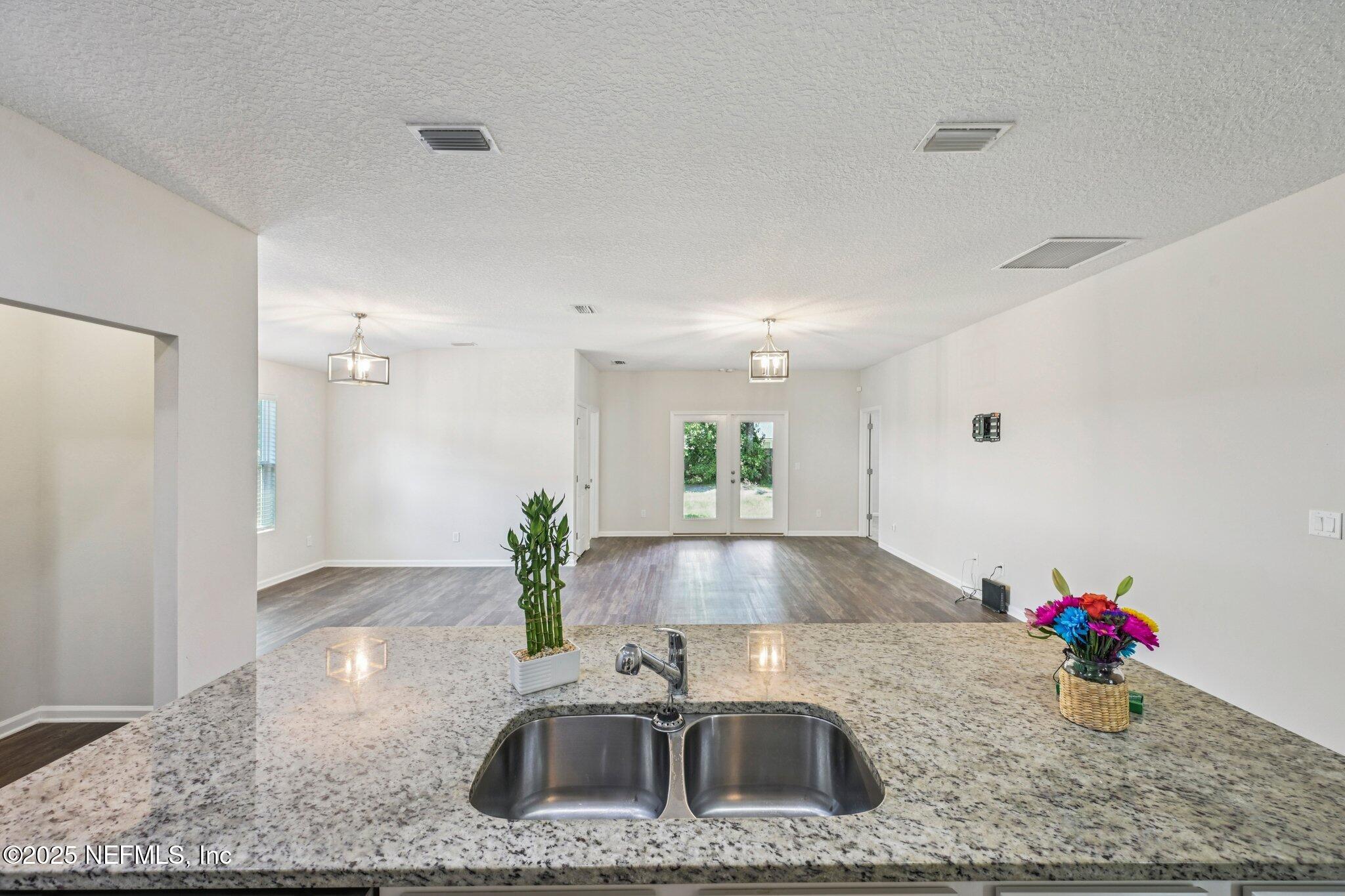 2400 Lundy Road Palatka, FL 32177 - Photo 5 of 34 a kitchen with stainless steel appliances granite countertop a sink a stove and a wooden cabinets