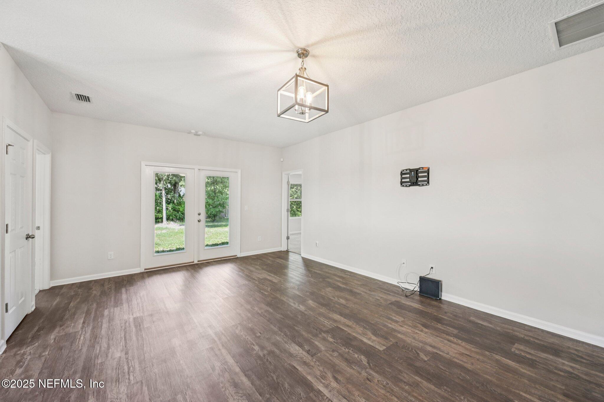 2400 Lundy Road Palatka, FL 32177 - Photo 8 of 34 a view of an empty room with wooden floor and a window