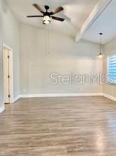512 Wideview Avenue Tarpon Springs, FL 34689 - Photo 13 of 30 a view of a room with wooden floor and ceiling fan