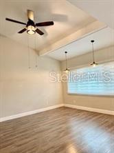 512 Wideview Avenue Tarpon Springs, FL 34689 - Photo 14 of 30 a view of a room with wooden floor and a ceiling fan