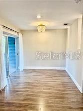 512 Wideview Avenue Tarpon Springs, FL 34689 - Photo 16 of 30 a view of an empty room with wooden floor and a window