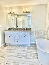 512 Wideview Avenue Tarpon Springs, FL 34689 - Photo 21 of 30 a bathroom with a granite countertop sink and a bathtub