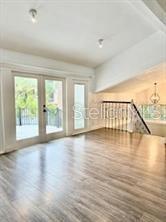 512 Wideview Avenue Tarpon Springs, FL 34689 - Photo 5 of 30 wooden floor in an empty room with a window