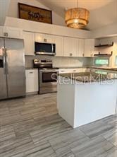 512 Wideview Avenue Tarpon Springs, FL 34689 - Photo 6 of 30 a kitchen with stainless steel appliances a stove and microwave