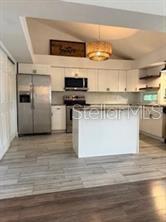 512 Wideview Avenue Tarpon Springs, FL 34689 - Photo 10 of 30 a kitchen with stainless steel appliances granite countertop a stove and a refrigerator