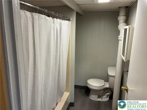 a white toilet sitting next to a small sink