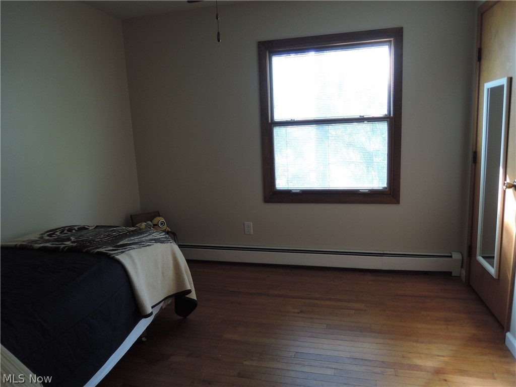 8002 Mulberry Road Chesterland, OH 44026 - Photo 16 of 18 One of 4 bedrooms with a ceiling fan and a light in the closet. Hardwood floor.