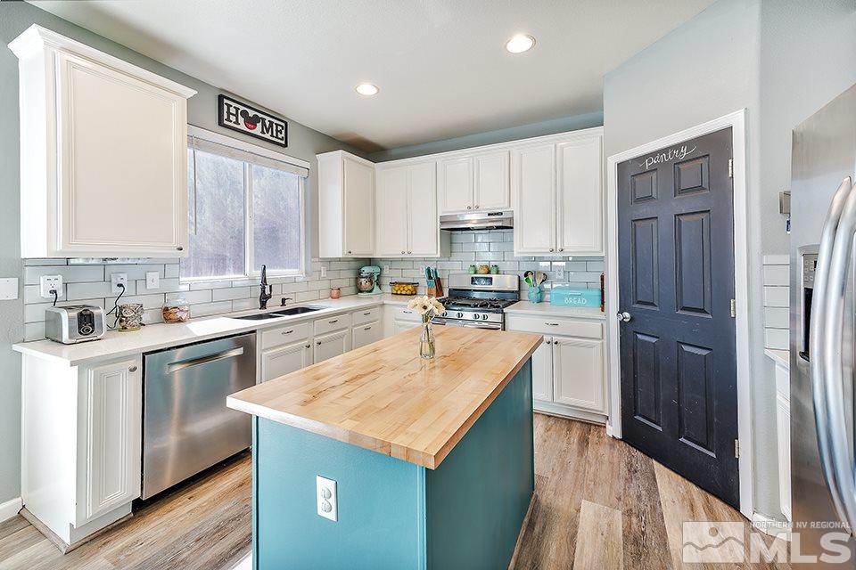 2252 Big Trail Circle Reno, NV 89521 - Photo 7 of 21 a kitchen with a refrigerator a sink and cabinets