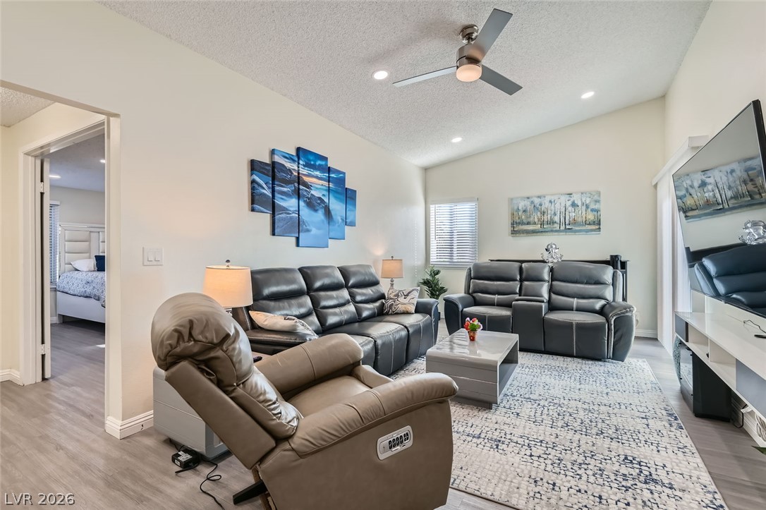 3665 Bronco Road Las Vegas, NV 89103 - Photo 4 of 28 Vivid living area with vaulted ceilings and abundant natural light offers a welcoming space.