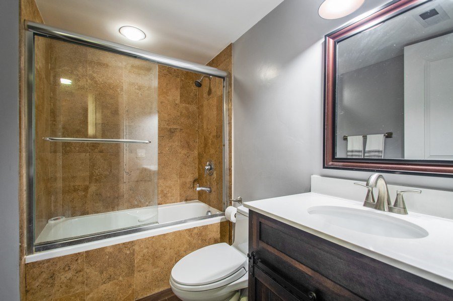 2549 North Clark Street, Unit G Chicago, IL 60614 - Photo 7 of 8 a bathroom with a sink a toilet and shower