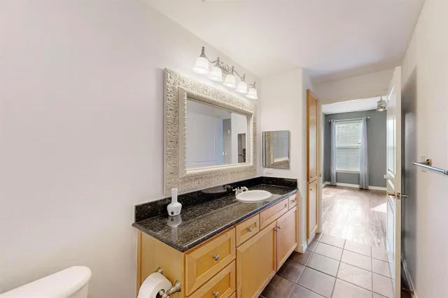 a spacious bathroom with a granite countertop sink and a mirror