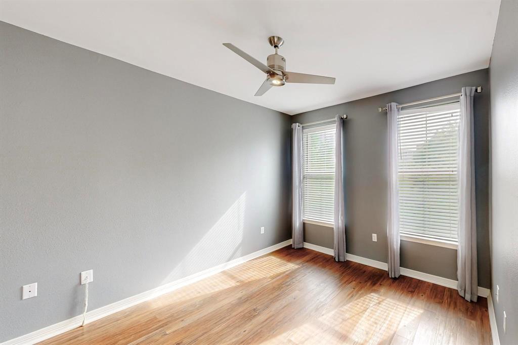 330 Las Colinas Boulevard East, Unit 342 Irving, TX 75039 - Photo 8 of 19 an empty room with wooden floor fan and windows