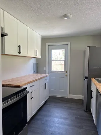 a kitchen with cabinets appliances and a counter space