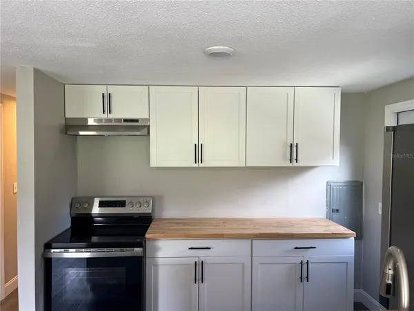 a kitchen with cabinets appliances and a window