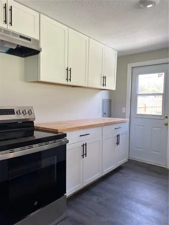 a kitchen with a sink and refrigerator