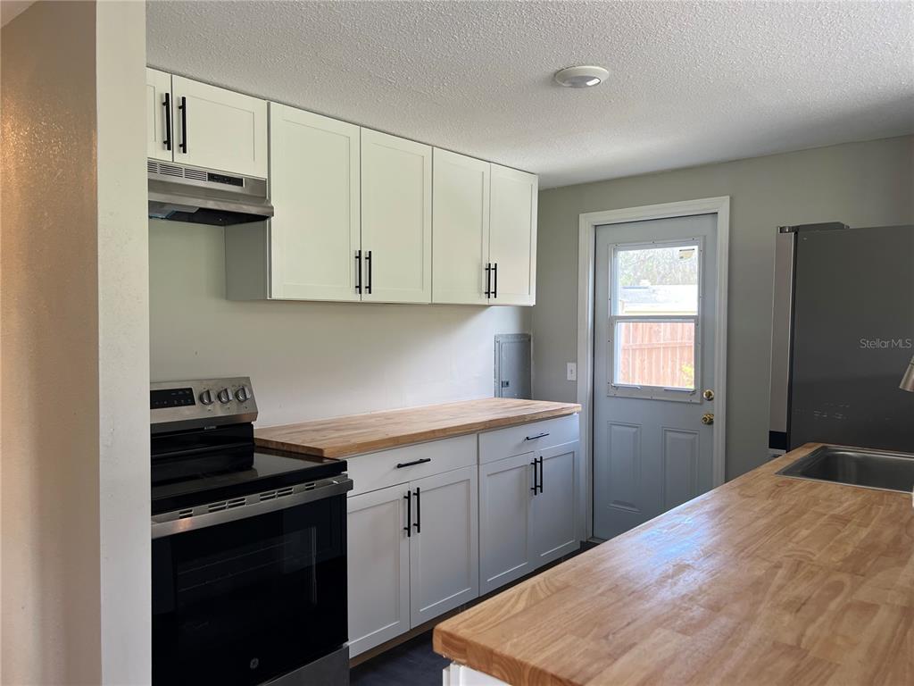 6287 Magnolia Street Keystone Heights, FL 32656 - Photo 17 of 27 a kitchen with a sink stove and cabinets
