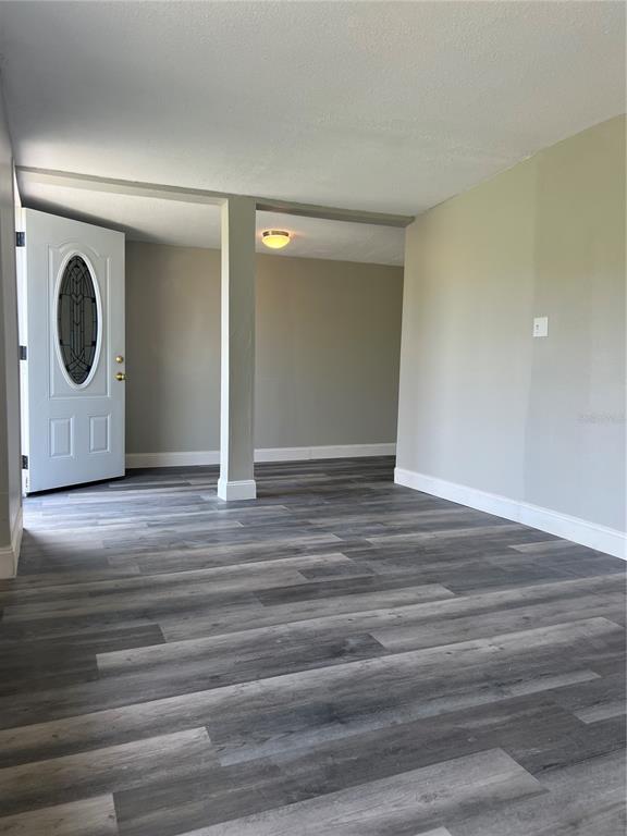 6287 Magnolia Street Keystone Heights, FL 32656 - Photo 18 of 27 a view of an empty room with wooden floor and a window
