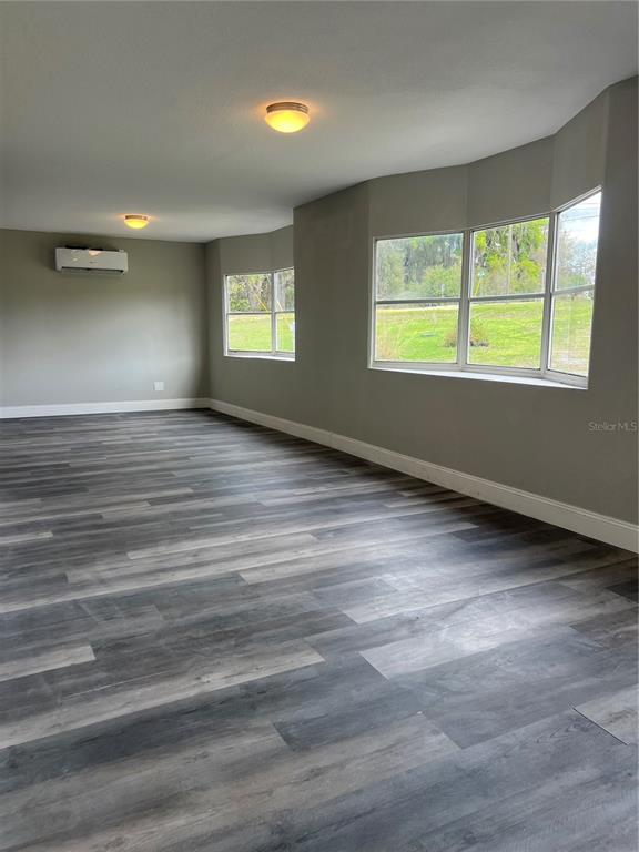 6287 Magnolia Street Keystone Heights, FL 32656 - Photo 19 of 27 wooden floor in an empty room with a window