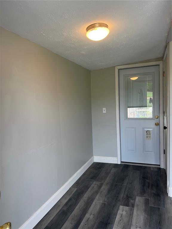 6287 Magnolia Street Keystone Heights, FL 32656 - Photo 20 of 27 an empty room with wooden floor and windows