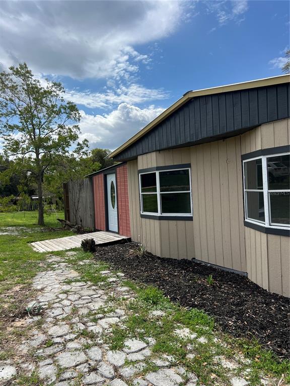 6287 Magnolia Street Keystone Heights, FL 32656 - Photo 2 of 27 a house with trees in the background