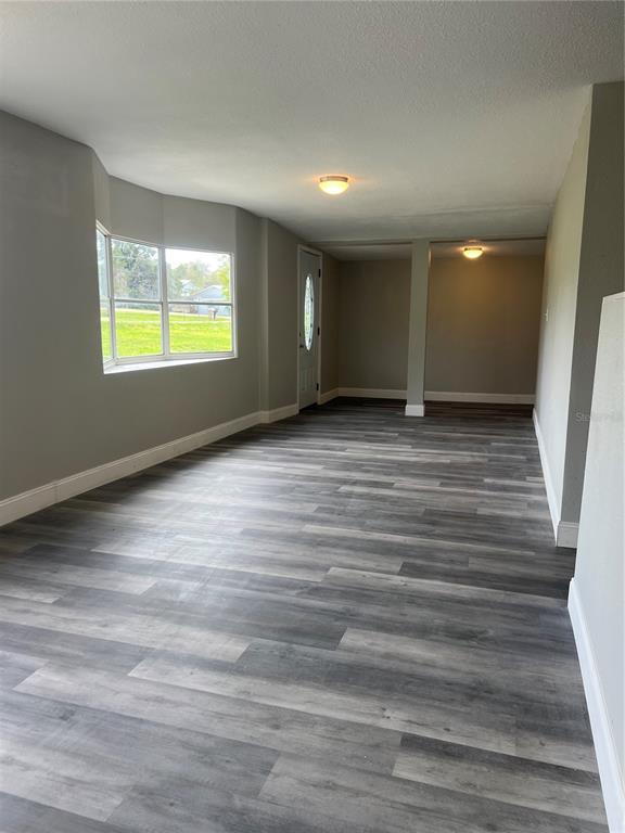 6287 Magnolia Street Keystone Heights, FL 32656 - Photo 21 of 27 a view of an empty room with wooden floor and a window