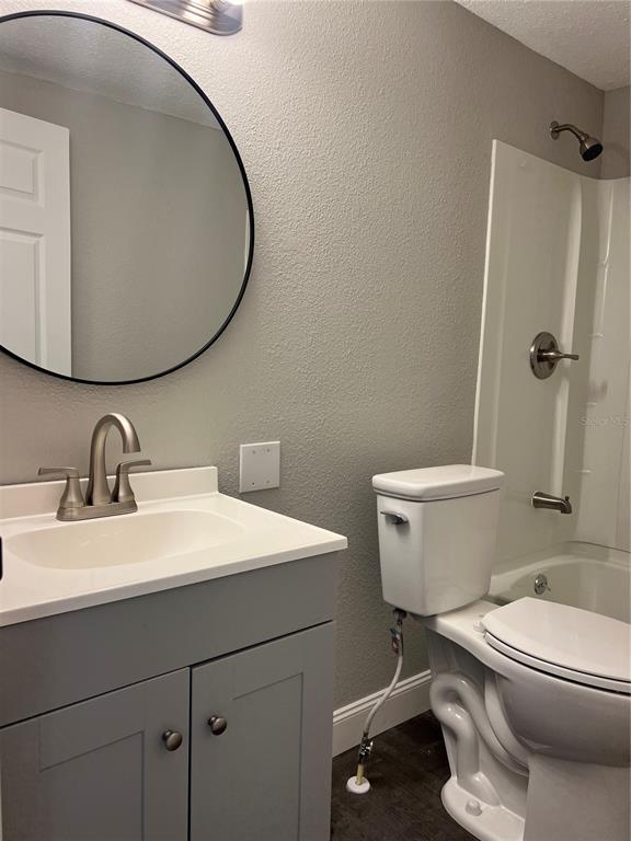 6287 Magnolia Street Keystone Heights, FL 32656 - Photo 22 of 27 a bathroom with a sink mirror vanity and toilet
