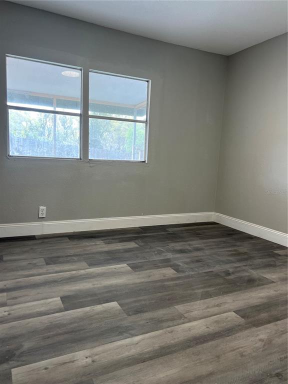6287 Magnolia Street Keystone Heights, FL 32656 - Photo 23 of 27 a view of a room that has wooden floor and window