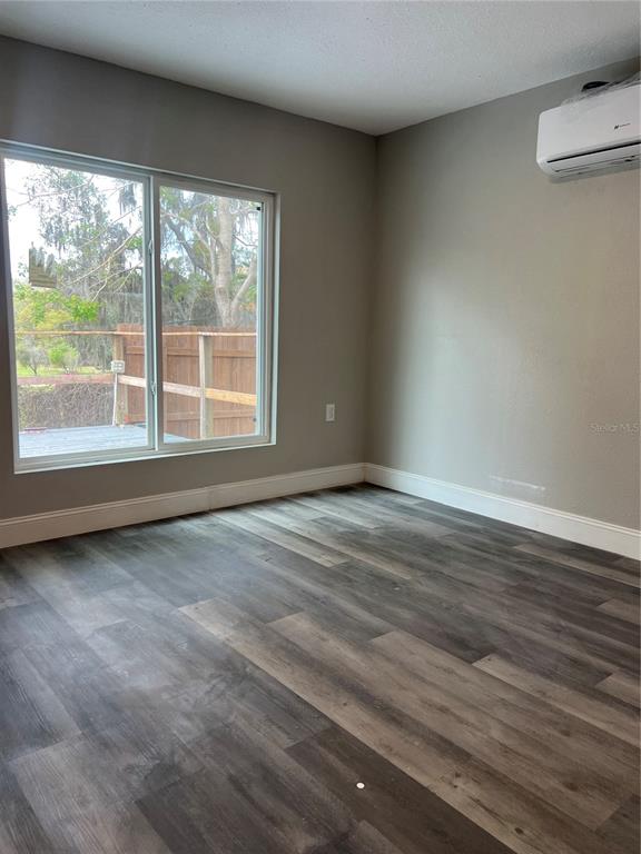 6287 Magnolia Street Keystone Heights, FL 32656 - Photo 26 of 27 a view of an empty room with wooden floor and a window