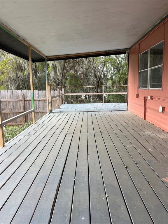 6287 Magnolia Street Keystone Heights, FL 32656 - Photo 10 of 27 a view of balcony with wooden floor and fence