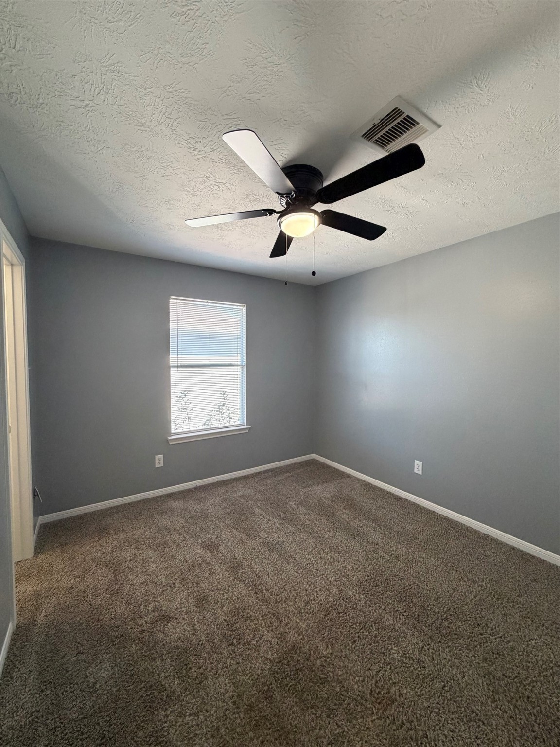 4623 Mi Castillo Court Houston, TX 77045 - Photo 23 of 25 an empty room with windows and fan