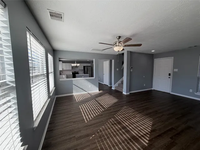a view of a livingroom with a hall and wooden floor