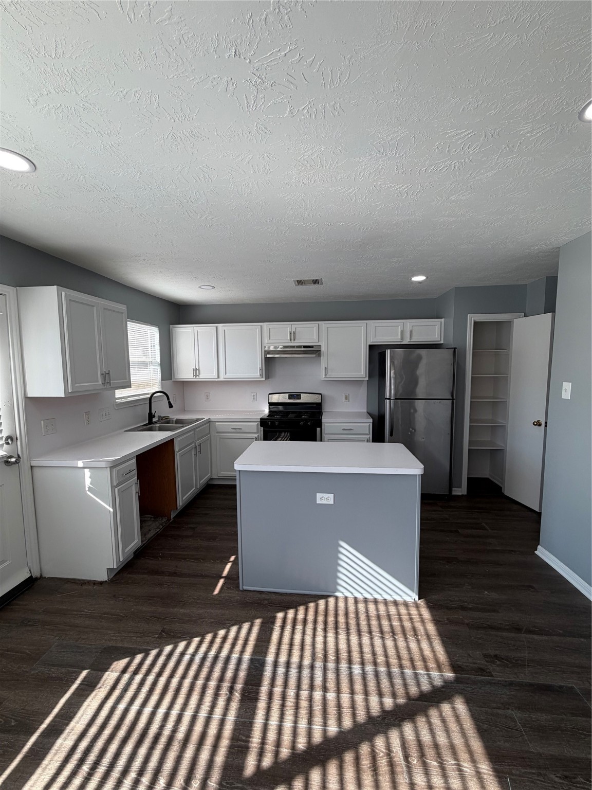 4623 Mi Castillo Court Houston, TX 77045 - Photo 6 of 25 a kitchen with a sink and wooden floor