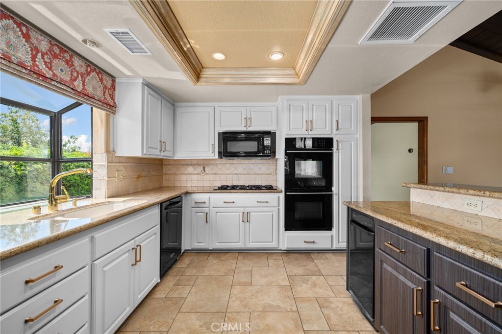 5297 Amethyst Street Rancho Cucamonga, CA 91737 - Photo 22 of 64 a large kitchen with stainless steel appliances granite countertop a stove and a sink
