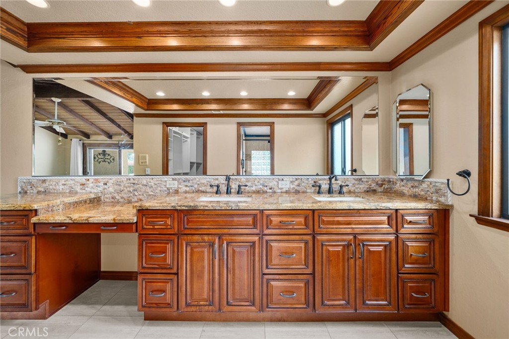 5297 Amethyst Street Rancho Cucamonga, CA 91737 - Photo 27 of 64 a bathroom with a granite countertop sink and a mirror