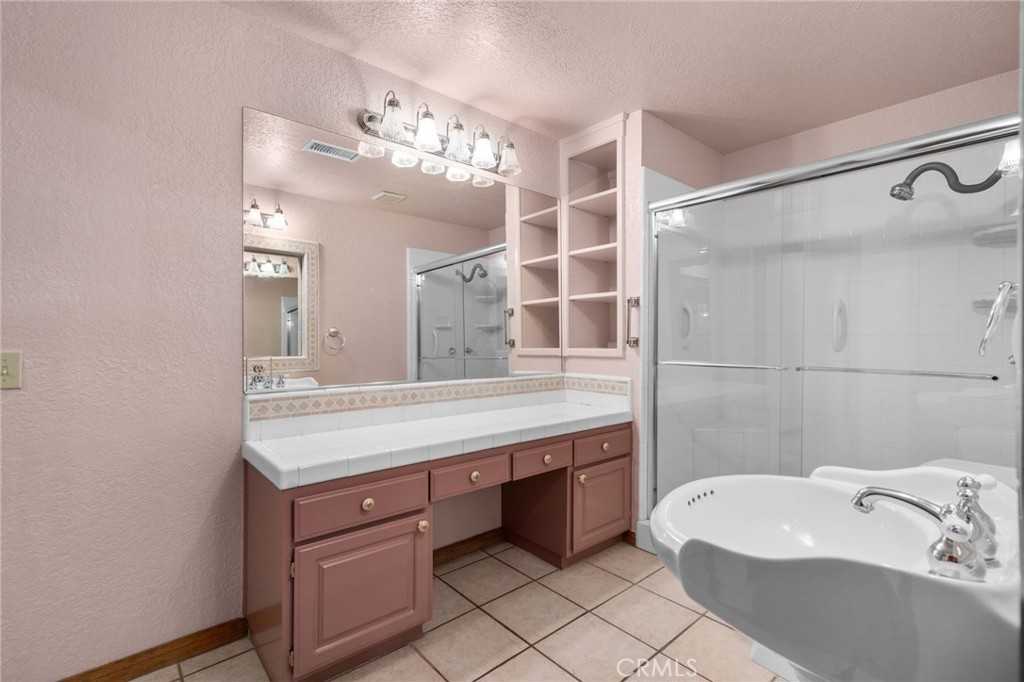 5297 Amethyst Street Rancho Cucamonga, CA 91737 - Photo 30 of 64 a bathroom with a tub sink and mirror