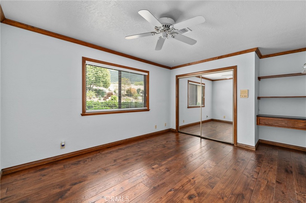 5297 Amethyst Street Rancho Cucamonga, CA 91737 - Photo 32 of 64 a view of an empty room with a window and wooden floor