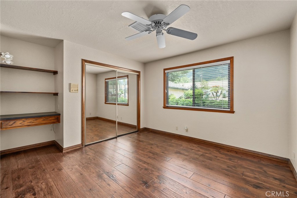 5297 Amethyst Street Rancho Cucamonga, CA 91737 - Photo 34 of 64 an empty room with wooden floor chandelier and windows