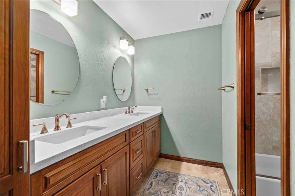 5297 Amethyst Street Rancho Cucamonga, CA 91737 - Photo 35 of 64 a spacious bathroom with a double vanity sink and a mirror