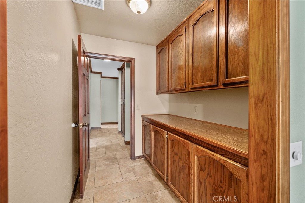 5297 Amethyst Street Rancho Cucamonga, CA 91737 - Photo 37 of 64 a kitchen with a refrigerator and cabinets