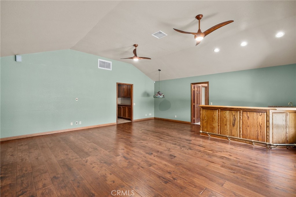 5297 Amethyst Street Rancho Cucamonga, CA 91737 - Photo 42 of 64 an empty room with wooden floor fan and windows