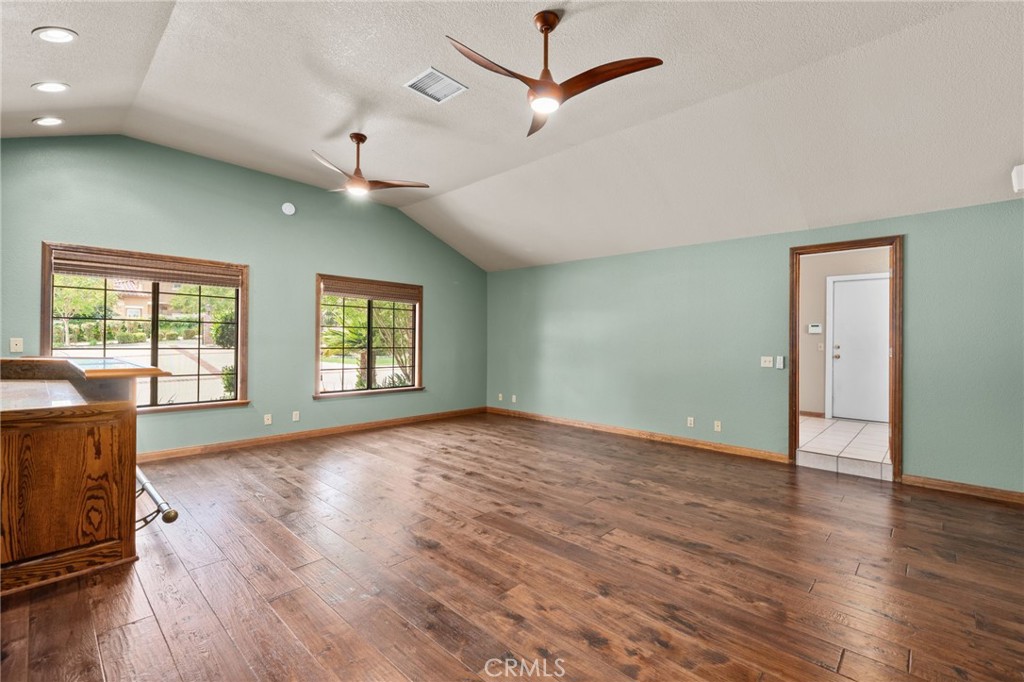 5297 Amethyst Street Rancho Cucamonga, CA 91737 - Photo 43 of 64 a view of an empty room with wooden floor and a window