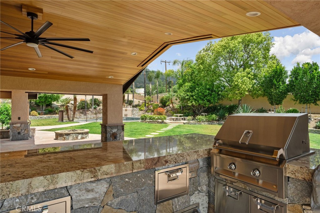 5297 Amethyst Street Rancho Cucamonga, CA 91737 - Photo 49 of 64 a view of a patio with table and chairs under an umbrella