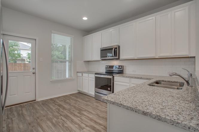 148 Spotted Rail Ridge Leander, TX 78641 - Photo 8 of 31 A well-equipped kitchen showcasing modern appliances and durable surfaces for everyday meal preparation.