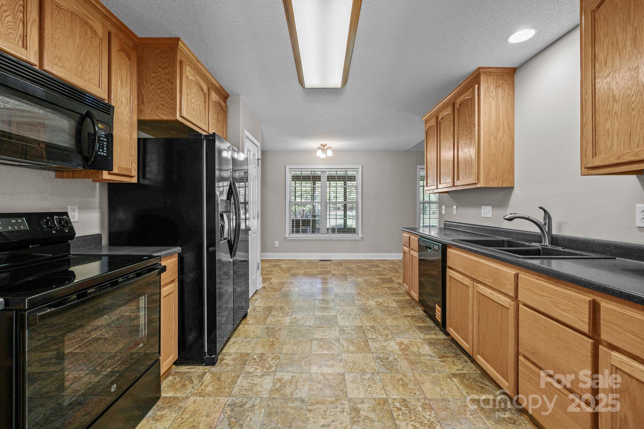 190 Teague Road Salisbury, NC 28146 - Photo 20 of 44 a kitchen with stainless steel appliances granite countertop a refrigerator a stove top oven a sink and dishwasher