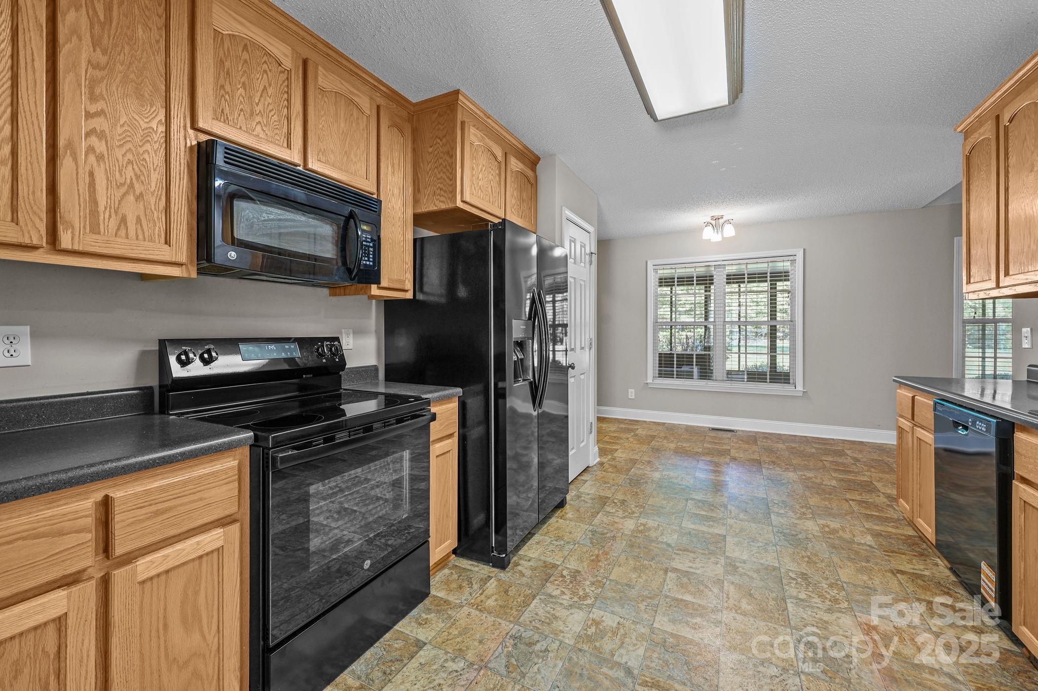 190 Teague Road Salisbury, NC 28146 - Photo 21 of 44 a kitchen with stainless steel appliances granite countertop a stove top oven a refrigerator a sink and dishwasher with white cabinets