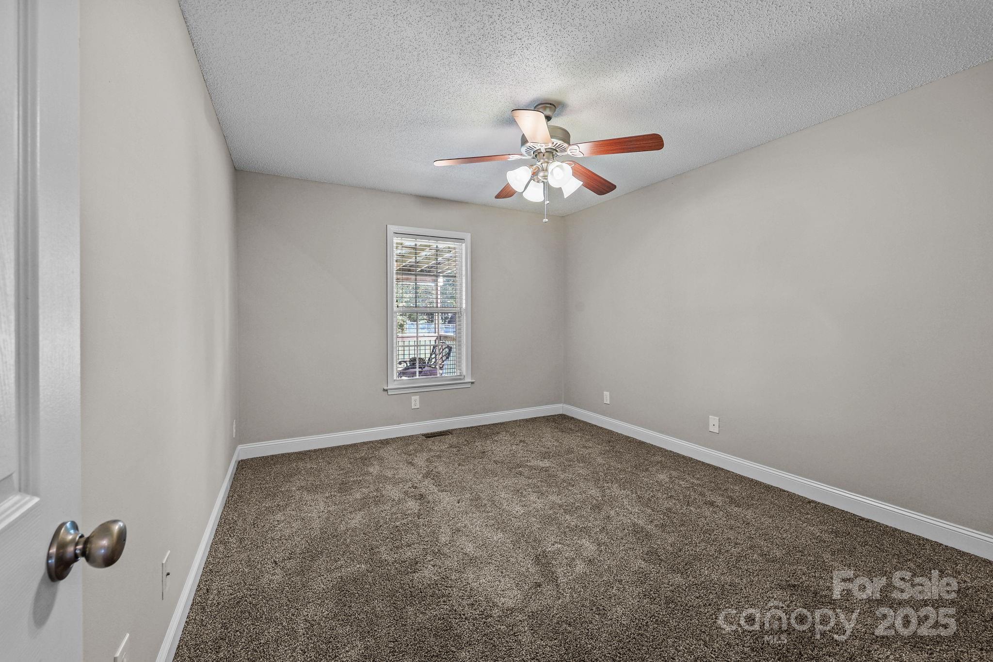 190 Teague Road Salisbury, NC 28146 - Photo 31 of 44 an empty room with windows and fan