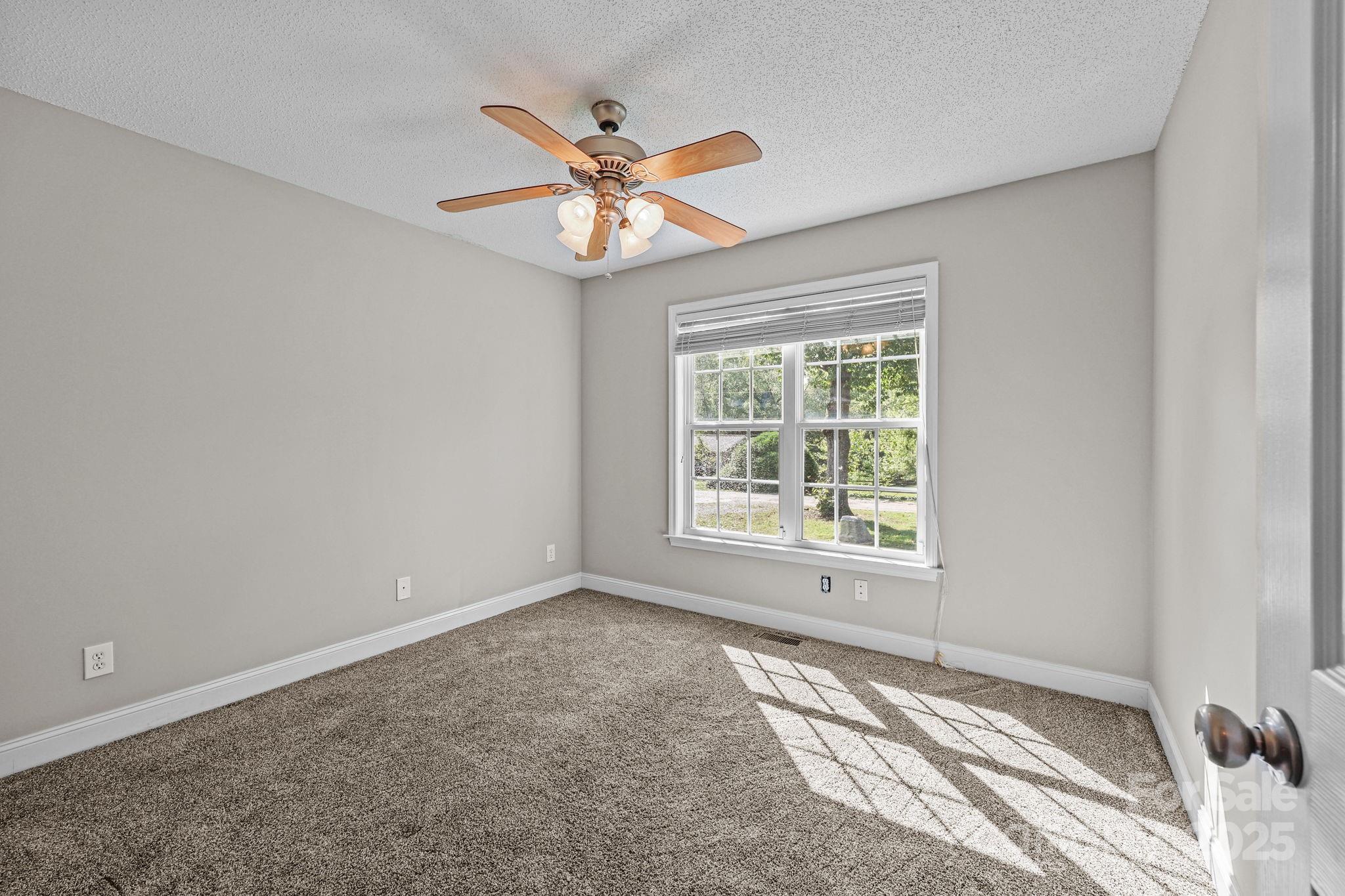 190 Teague Road Salisbury, NC 28146 - Photo 34 of 44 an empty room with a window and a fan