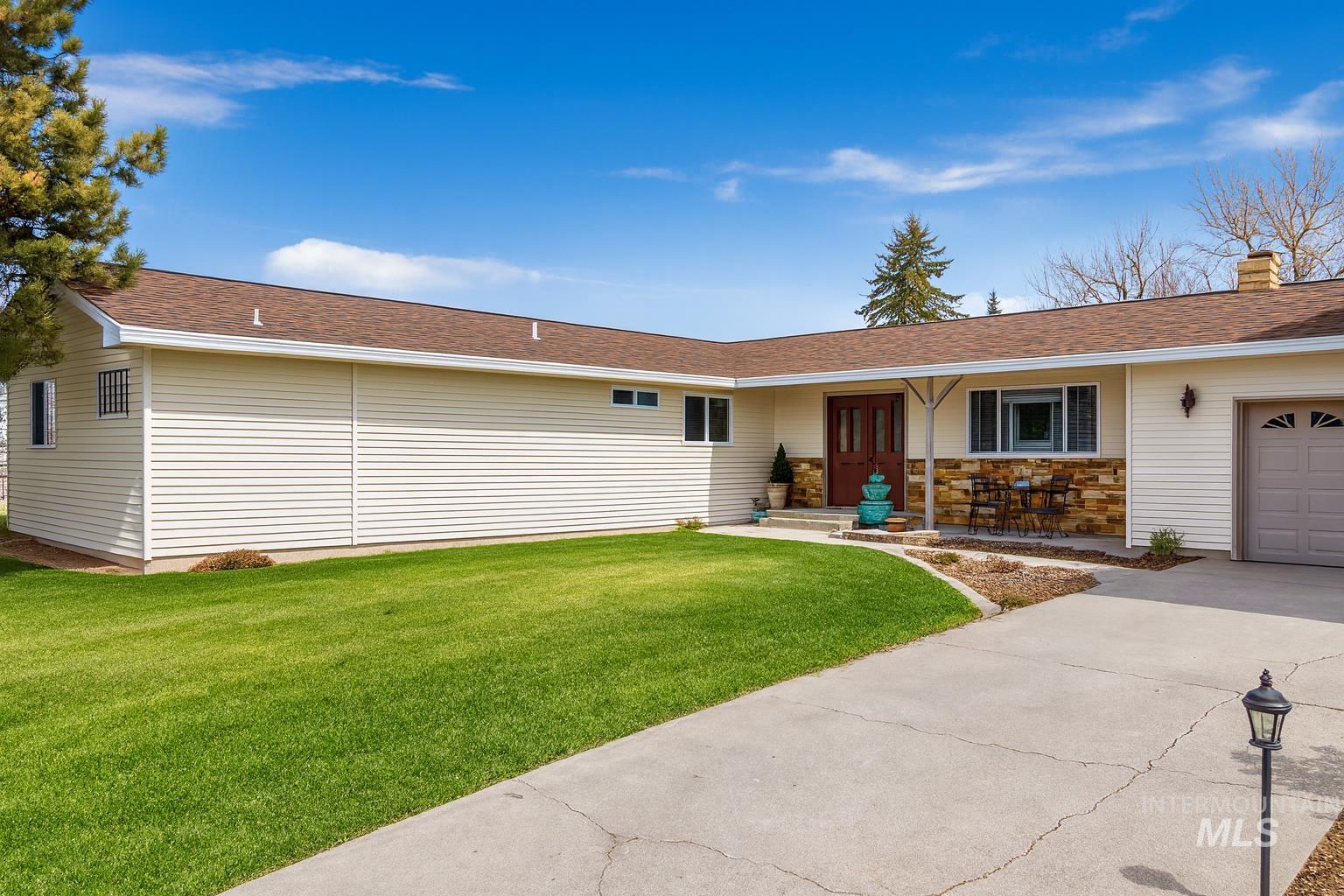 173 Fafnir Drive Kimberly, ID 83341 - Photo 28 of 42 Ranch-style home featuring roof with shingles, a front lawn, a garage, and stone siding