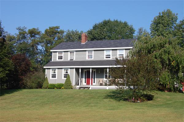 34 Tucker Road West Brookfield, MA 01585 - Photo 1 of 1 a front view of a house with a garden