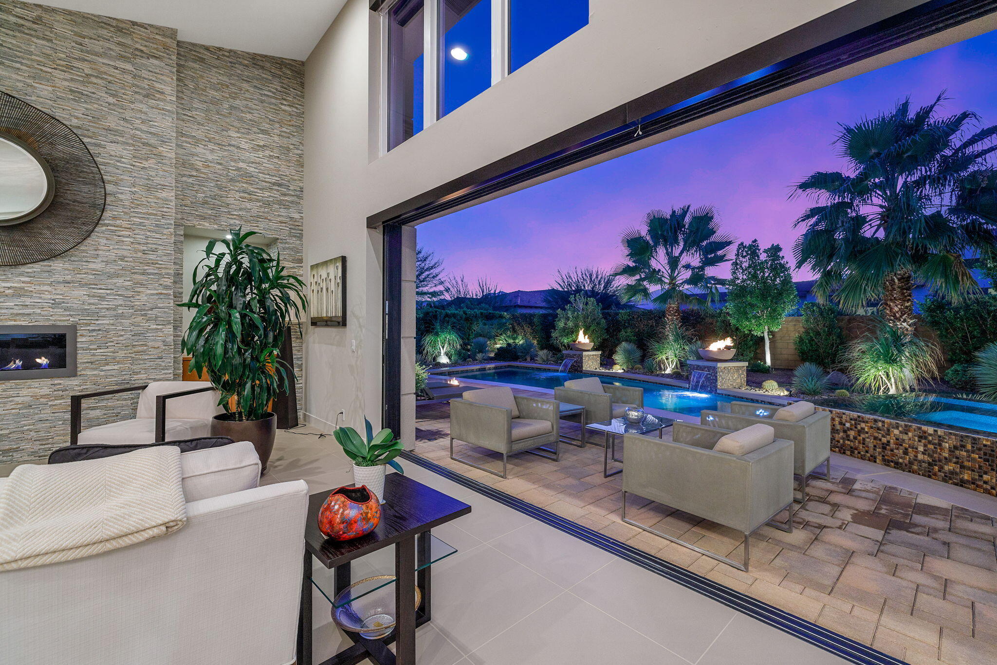 5 Via Merenda Rancho Mirage, CA 92270 - Photo 17 of 84 a view of a patio with couches and table and chairs with potted plants